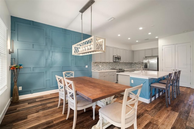 3326 Acacia Bay Ave, Wesley Chapel, FL 33543 - dining area featuring dark wood-type flooring, recessed lighting, and a decorative wall