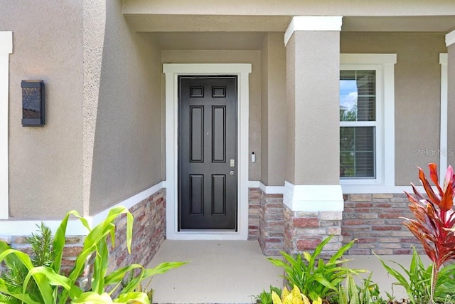 5430 Thistle Field Ct, Wesley Chapel, FL 33545 - doorway to property featuring stone siding and stucco siding