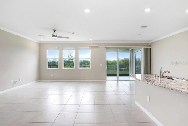 5430 Thistle Field Ct, Wesley Chapel, FL 33545 - empty room featuring healthy amount of natural light, ornamental molding, ceiling fan, recessed lighting, and light tile patterned floors