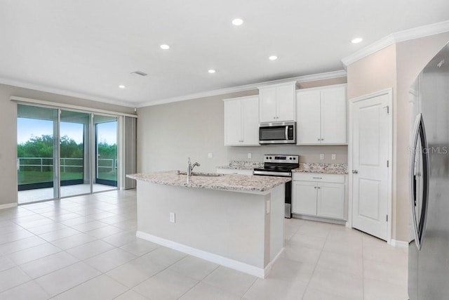 5430 Thistle Field Ct, Wesley Chapel, FL 33545 - kitchen featuring stainless steel appliances, crown molding, a center island with sink, light stone counters, and white cabinets