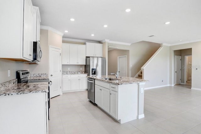 5430 Thistle Field Ct, Wesley Chapel, FL 33545 - kitchen featuring stainless steel appliances, ornamental molding, a kitchen island with sink, white cabinetry, and recessed lighting