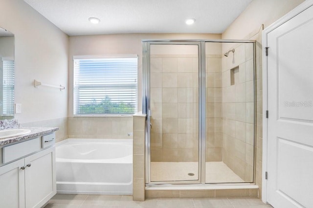 5430 Thistle Field Ct, Wesley Chapel, FL 33545 - full bathroom featuring vanity, a bath, a shower stall, and tile patterned floors