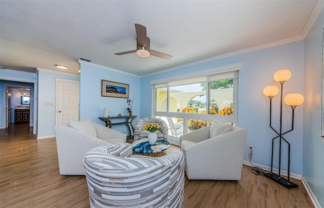 14534 Yacht Club Blvd, Seminole, FL 33776 - living area with wood finished floors, ceiling fan, and ornamental molding