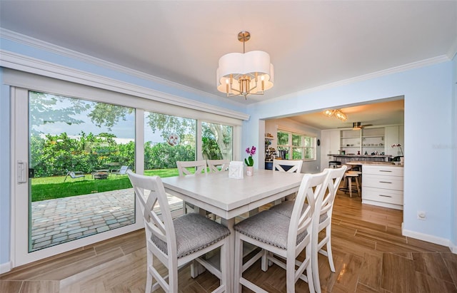 14534 Yacht Club Blvd, Seminole, FL 33776 - dining room with a chandelier, ornamental molding, and wood finished floors