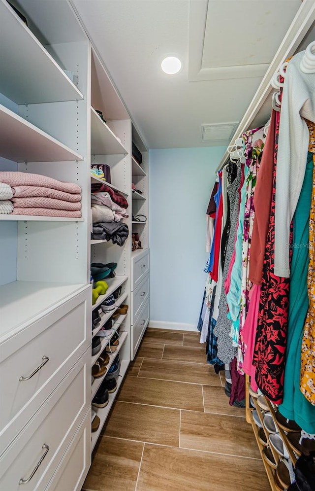 14534 Yacht Club Blvd, Seminole, FL 33776 - walk in closet featuring light wood finished floors and attic access