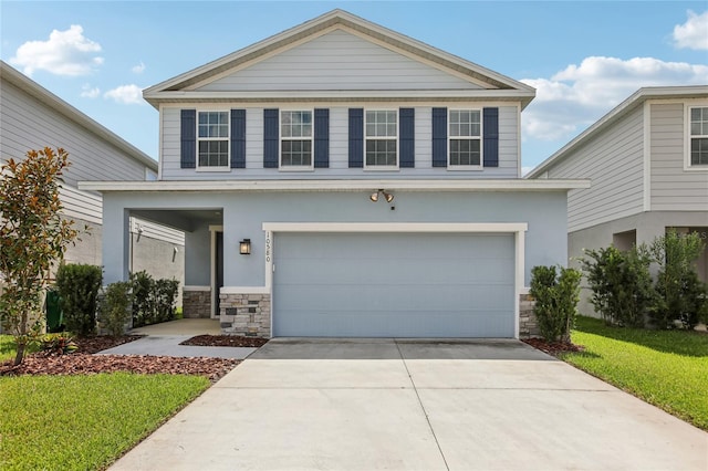 10580 Gliding Eagle Way, Land O Lakes, FL 34638 - view of front facade with stone siding, a garage, driveway, and a front yard