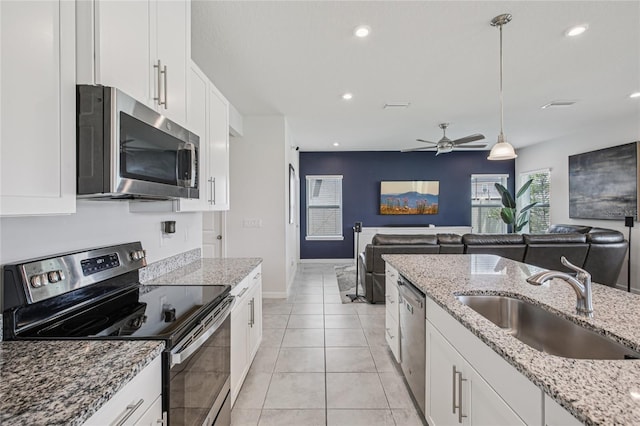 10580 Gliding Eagle Way, Land O Lakes, FL 34638 - kitchen with appliances with stainless steel finishes, open floor plan, white cabinetry, ceiling fan, and recessed lighting