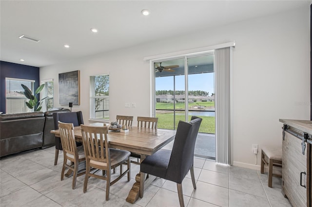 10580 Gliding Eagle Way, Land O Lakes, FL 34638 - dining space featuring light tile patterned floors, a water view, and recessed lighting