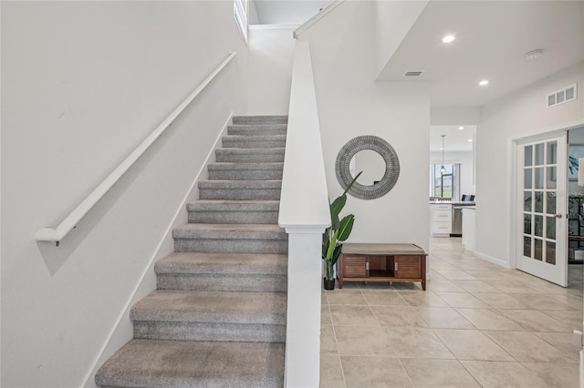 10580 Gliding Eagle Way, Land O Lakes, FL 34638 - stairway featuring tile patterned flooring, recessed lighting, and french doors