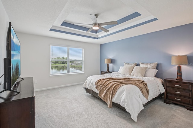 10580 Gliding Eagle Way, Land O Lakes, FL 34638 - bedroom featuring a raised ceiling, light colored carpet, and ceiling fan
