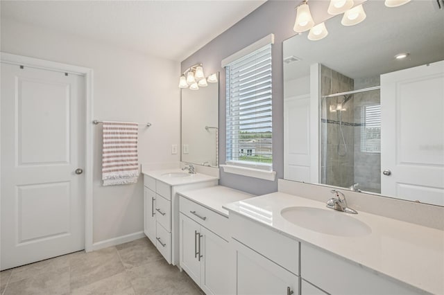 10580 Gliding Eagle Way, Land O Lakes, FL 34638 - bathroom with two vanities, a shower stall, and tile patterned floors