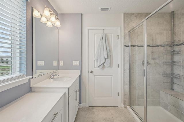 10580 Gliding Eagle Way, Land O Lakes, FL 34638 - full bathroom with vanity, a stall shower, healthy amount of natural light, and tile patterned flooring