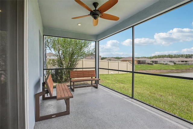 10580 Gliding Eagle Way, Land O Lakes, FL 34638 - unfurnished sunroom featuring ceiling fan, a residential view, and a water view