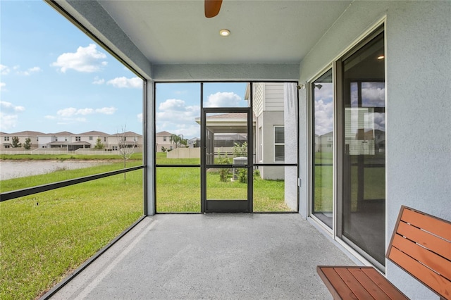 10580 Gliding Eagle Way, Land O Lakes, FL 34638 - unfurnished sunroom with a residential view and a ceiling fan