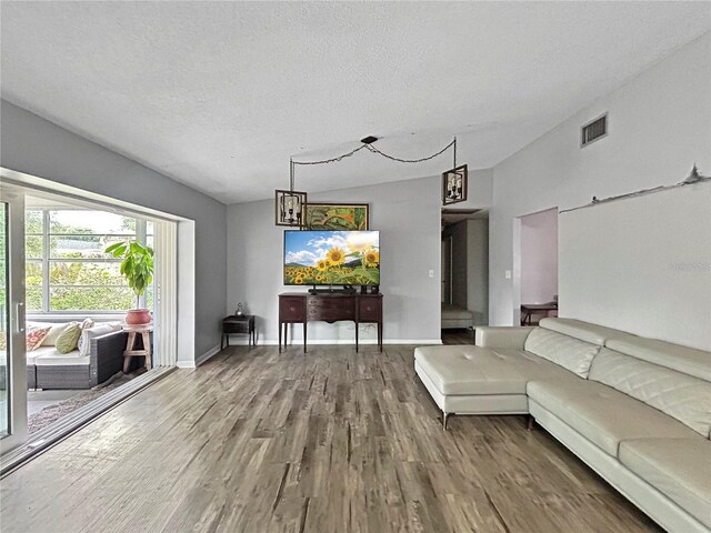 1609 Haven Bnd, Tampa, FL 33613 - living area featuring wood finished floors and lofted ceiling