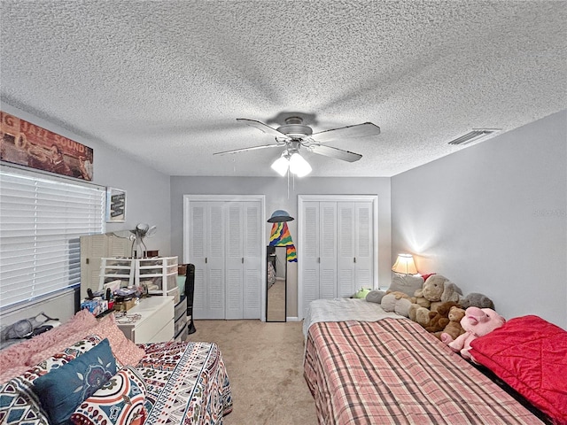 1609 Haven Bnd, Tampa, FL 33613 - bedroom featuring multiple closets, light carpet, and a ceiling fan