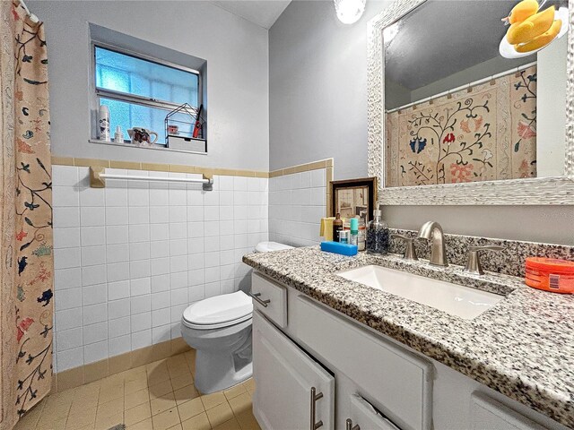 1609 Haven Bnd, Tampa, FL 33613 - bathroom featuring tile walls, tile patterned flooring, vanity, a wainscoted wall, and curtained shower