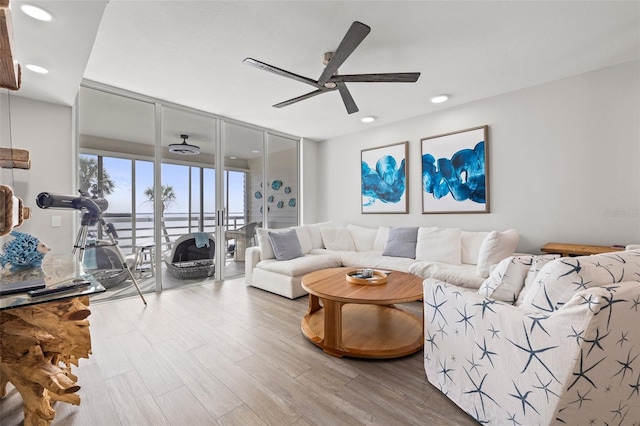 615 Dream Island Pl Unit 210, Longboat Key, FL 34228 - living room with expansive windows, ceiling fan, wood finished floors, and recessed lighting