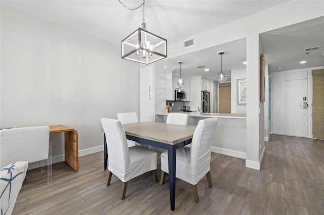 615 Dream Island Pl Unit 210, Longboat Key, FL 34228 - dining space with a chandelier, wood finished floors, and recessed lighting