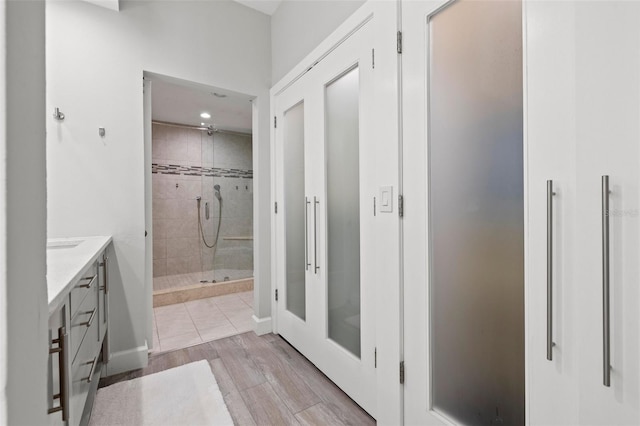 615 Dream Island Pl Unit 210, Longboat Key, FL 34228 - bathroom featuring a shower stall, vanity, and wood finished floors