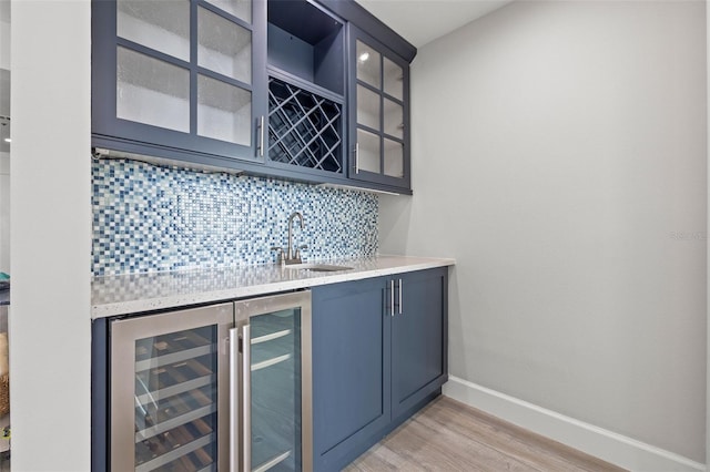 615 Dream Island Pl Unit 210, Longboat Key, FL 34228 - indoor wet bar featuring decorative backsplash, light wood finished floors, and wine cooler