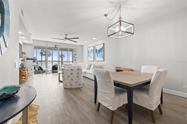 615 Dream Island Pl Unit 210, Longboat Key, FL 34228 - dining area with wood finished floors, a chandelier, ceiling fan, and recessed lighting