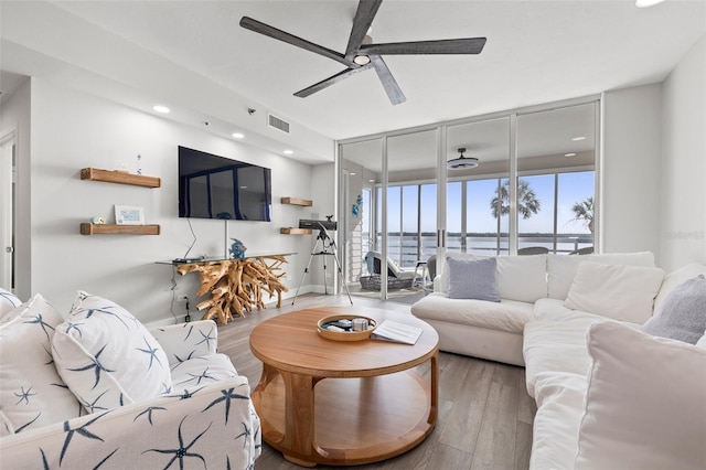 615 Dream Island Pl Unit 210, Longboat Key, FL 34228 - living room with ceiling fan, wood finished floors, and recessed lighting