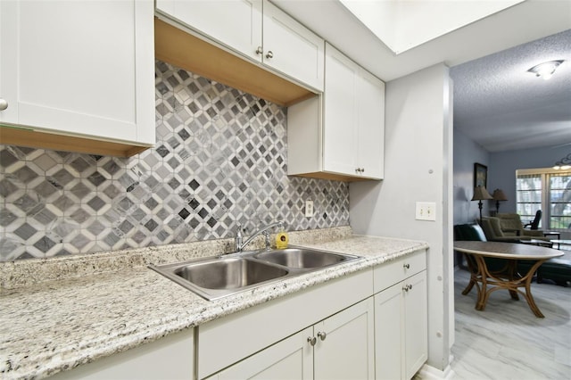 2003 Greenbriar Blvd Unit 8, Clearwater, FL 33763 - kitchen featuring white cabinets and tasteful backsplash