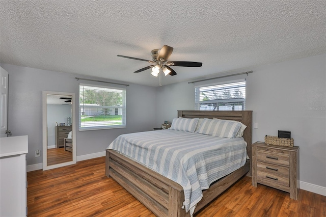 540 Firefly Ln, Apollo Beach, FL 33572 - bedroom with wood finished floors, a textured ceiling, and a ceiling fan