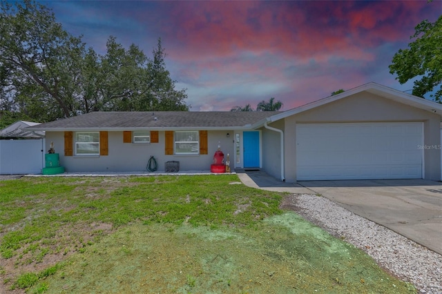 540 Firefly Ln, Apollo Beach, FL 33572 - ranch-style home featuring stucco siding, an attached garage, concrete driveway, and a yard