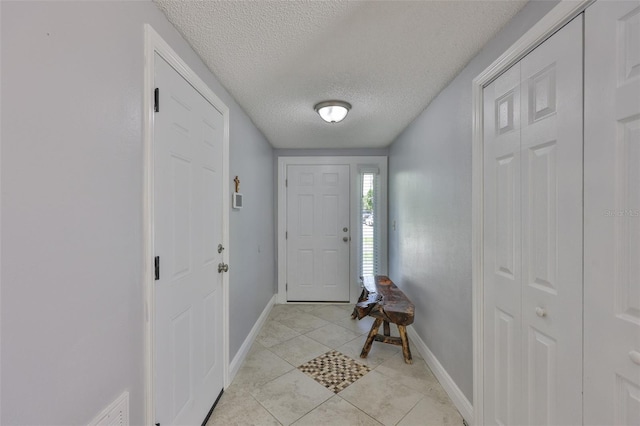 540 Firefly Ln, Apollo Beach, FL 33572 - entryway featuring light tile patterned floors and a textured ceiling