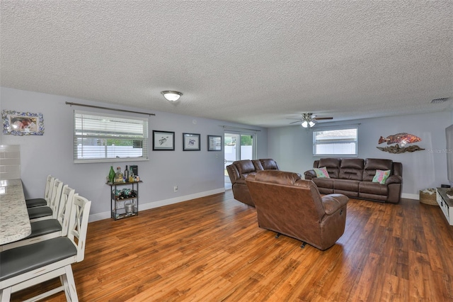 540 Firefly Ln, Apollo Beach, FL 33572 - living area featuring wood finished floors, a ceiling fan, healthy amount of natural light, and a textured ceiling