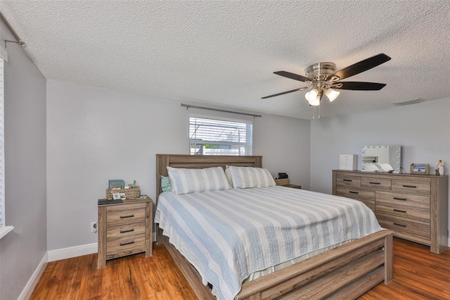 540 Firefly Ln, Apollo Beach, FL 33572 - bedroom featuring wood finished floors, a textured ceiling, and ceiling fan