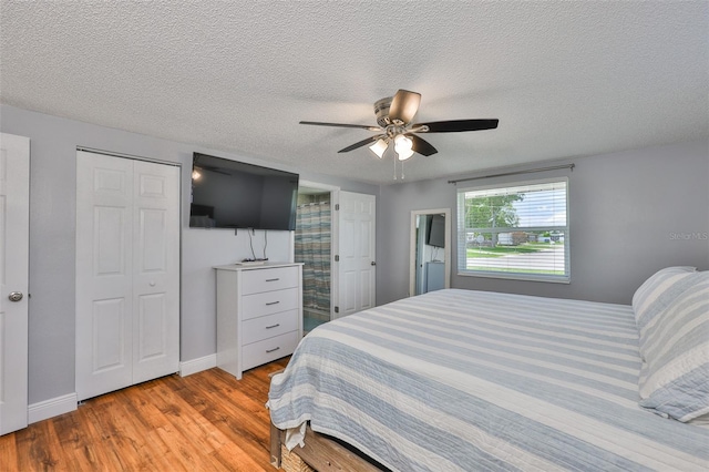 540 Firefly Ln, Apollo Beach, FL 33572 - bedroom featuring wood finished floors, a textured ceiling, and a ceiling fan