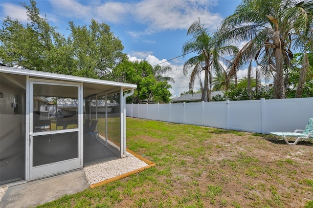 540 Firefly Ln, Apollo Beach, FL 33572 - fenced backyard with a sunroom