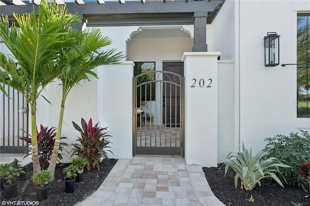 19781 Marino Lake Cir Unit 202, Miromar Lakes, FL 33913 - property entrance with stucco siding and a gate