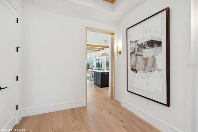 19781 Marino Lake Cir Unit 202, Miromar Lakes, FL 33913 - hallway with light wood-type flooring and a chandelier