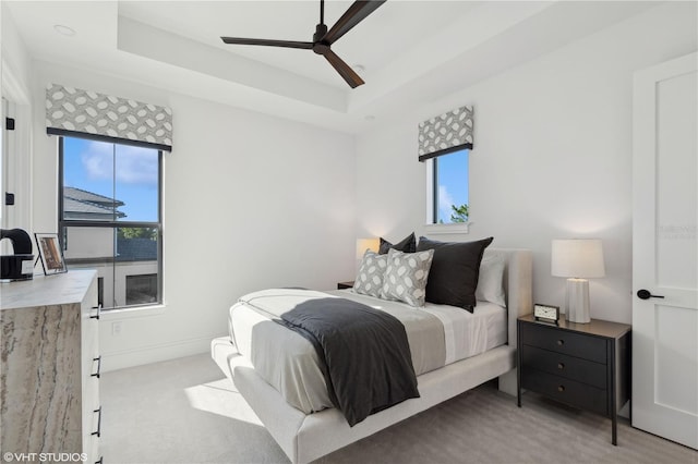 19781 Marino Lake Cir Unit 202, Miromar Lakes, FL 33913 - bedroom featuring multiple windows, carpet, a tray ceiling, and a ceiling fan
