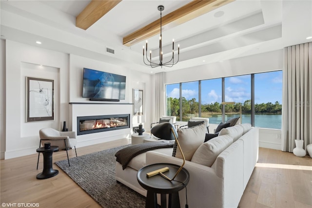 19781 Marino Lake Cir Unit 202, Miromar Lakes, FL 33913 - living area featuring a glass covered fireplace, light wood-style floors, beam ceiling, a chandelier, and recessed lighting