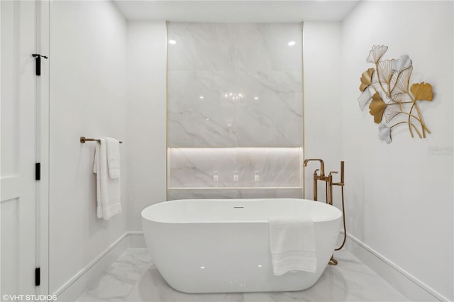 19781 Marino Lake Cir Unit 202, Miromar Lakes, FL 33913 - bathroom featuring marble look tile flooring and a freestanding bath