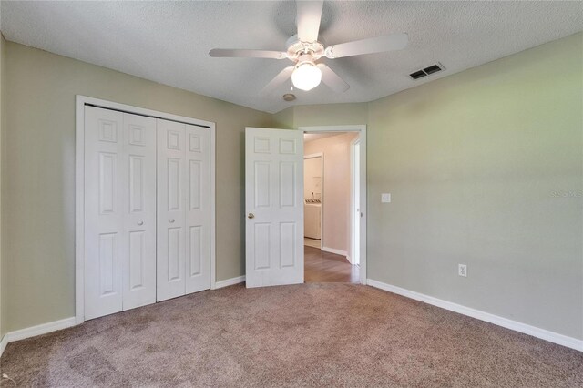 2719 Wilder Trace Ct, Plant City, FL 33566 - unfurnished bedroom featuring washer / dryer, carpet flooring, a closet, a textured ceiling, and a ceiling fan