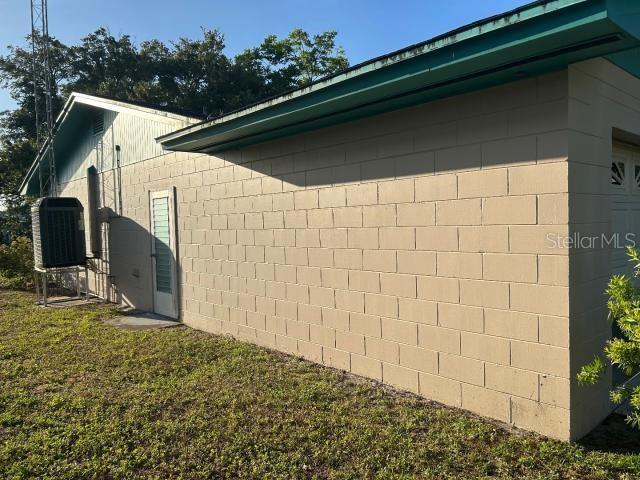 3901 N Nokomis Pt, Crystal River, FL 34428 - view of side of property with a central AC unit and concrete block siding