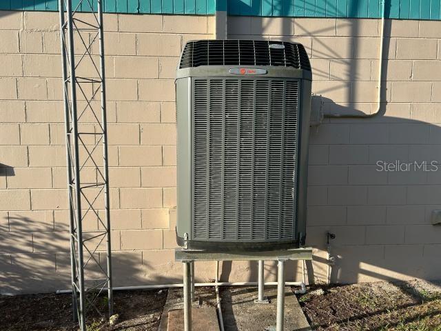3901 N Nokomis Pt, Crystal River, FL 34428 - exterior view of a central AC unit and concrete block siding