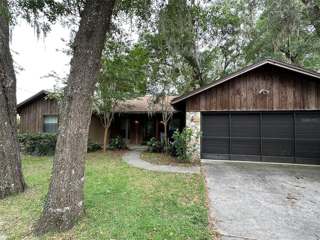 6262 E Rector St, Inverness, FL 34452 - view of front facade with a garage, a front lawn, and stone siding