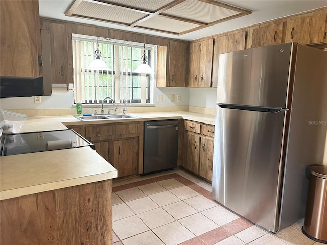 6262 E Rector St, Inverness, FL 34452 - kitchen featuring appliances with stainless steel finishes, light countertops, brown cabinets, light tile patterned floors, and decorative light fixtures
