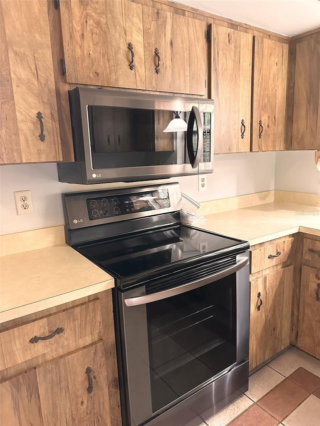 6262 E Rector St, Inverness, FL 34452 - kitchen with appliances with stainless steel finishes, light countertops, and brown cabinets