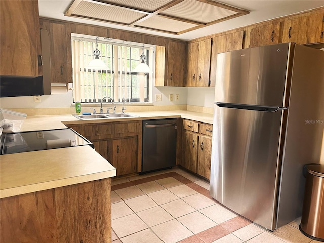 6262 E Rector St, Inverness, FL 34452 - kitchen featuring appliances with stainless steel finishes, light countertops, brown cabinets, light tile patterned floors, and hanging light fixtures