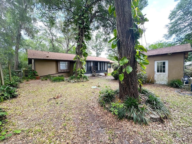 6262 E Rector St, Inverness, FL 34452 - view of front of house featuring stucco siding and a sunroom