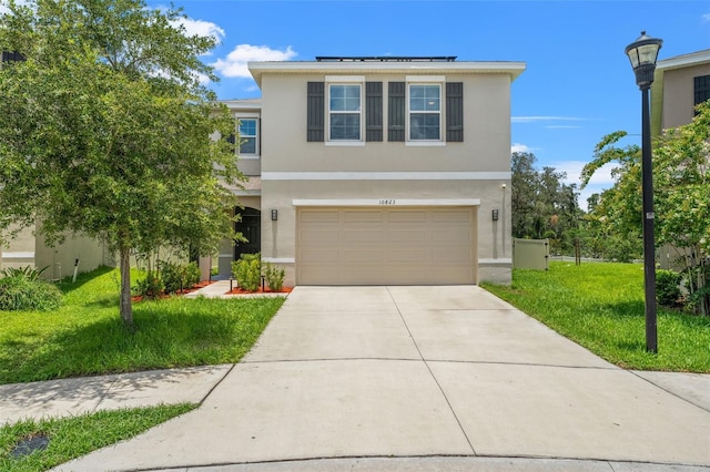 10823 Trailing Vine Dr, Tampa, FL 33610 - view of front of property with stucco siding, solar panels, driveway, a front lawn, and an attached garage