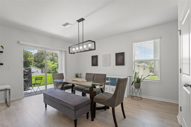 10823 Trailing Vine Dr, Tampa, FL 33610 - dining space featuring light wood-type flooring and a chandelier